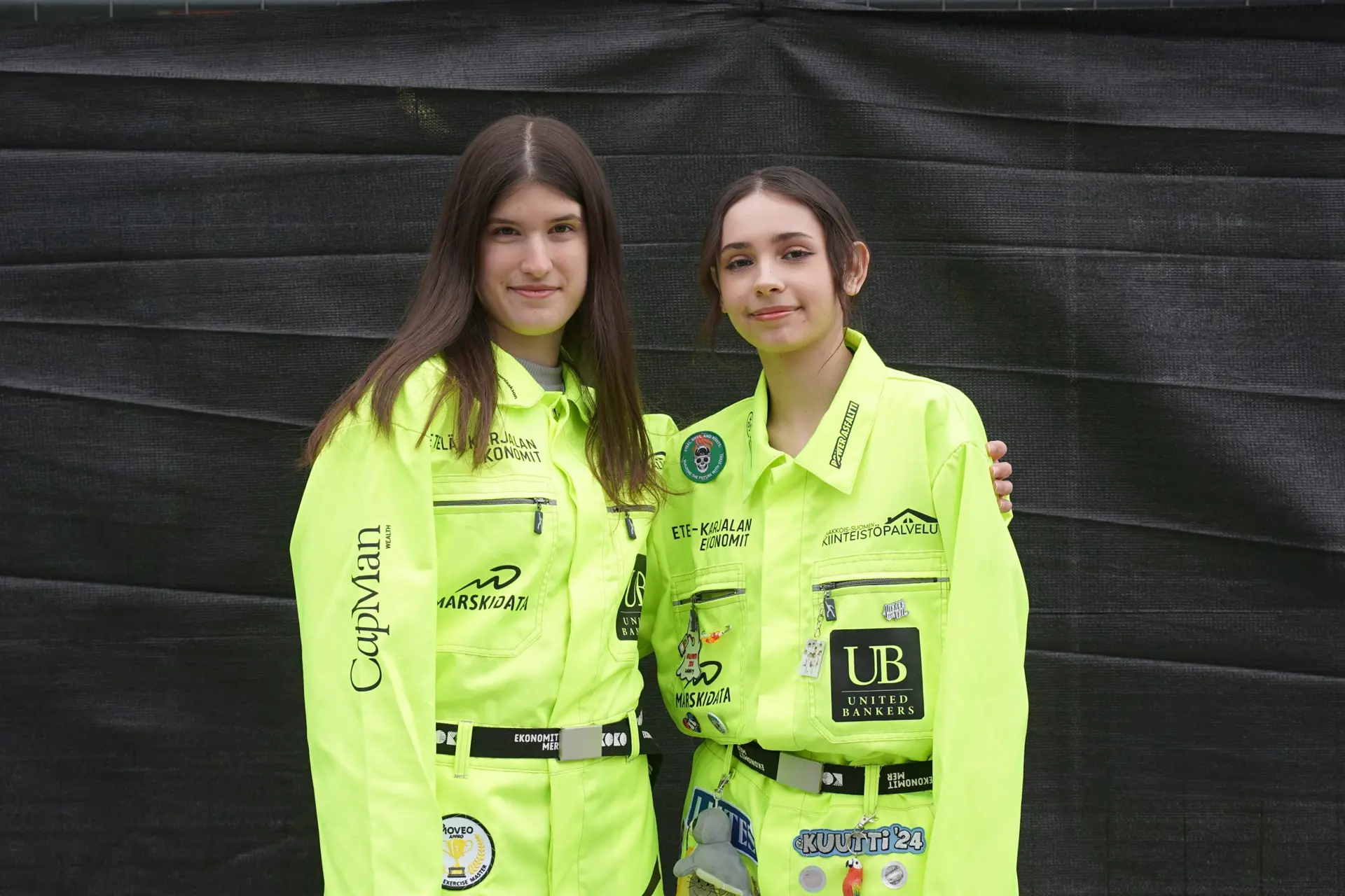 Two students in neon yellow overalls