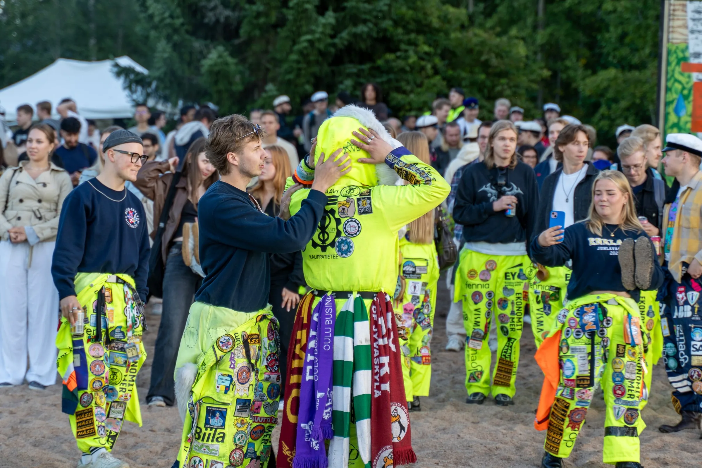 Students in overalls at an outdoor festival